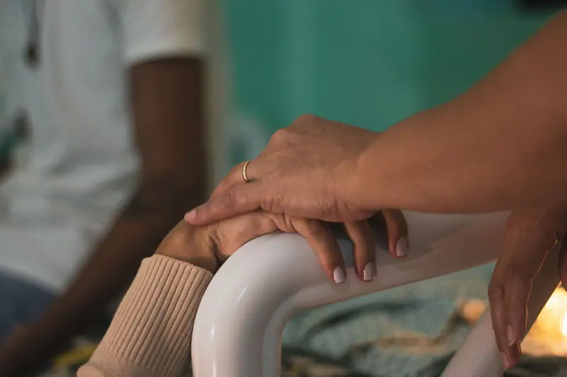 Hands touching at the bedside