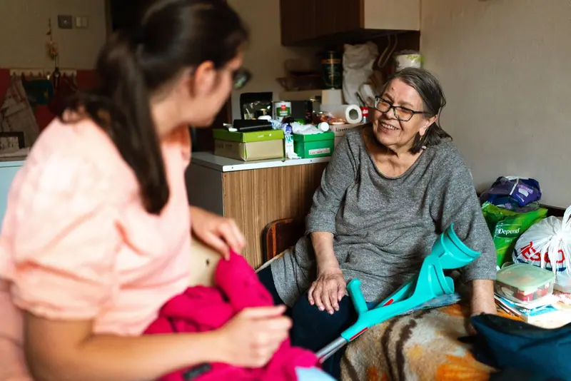 A caregiver steadying a patient at home
