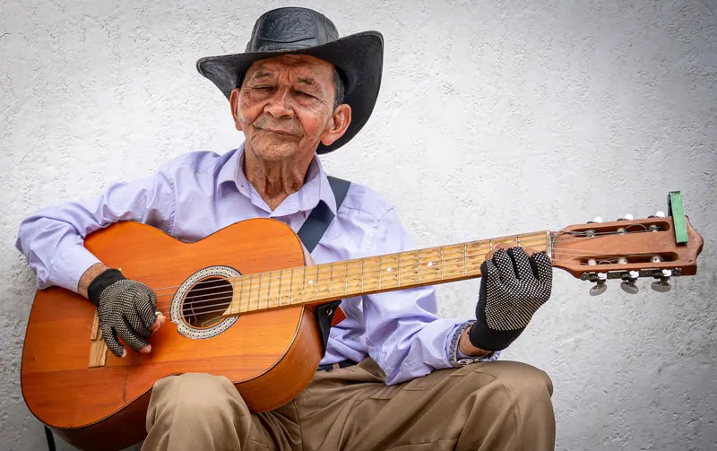 An old cowboy playing his guitar