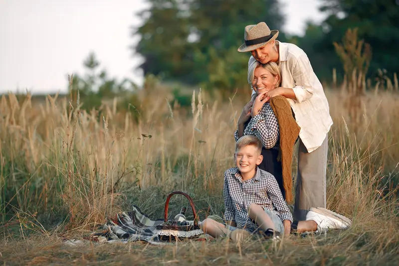 Three generations on a picnic in the tall grass