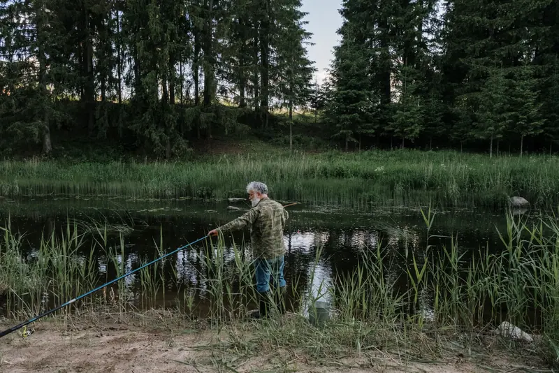 A man fishing at the water's edge