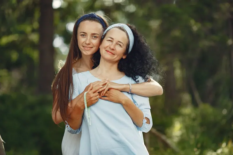 A mother and daughter sharing a quiet moment outside