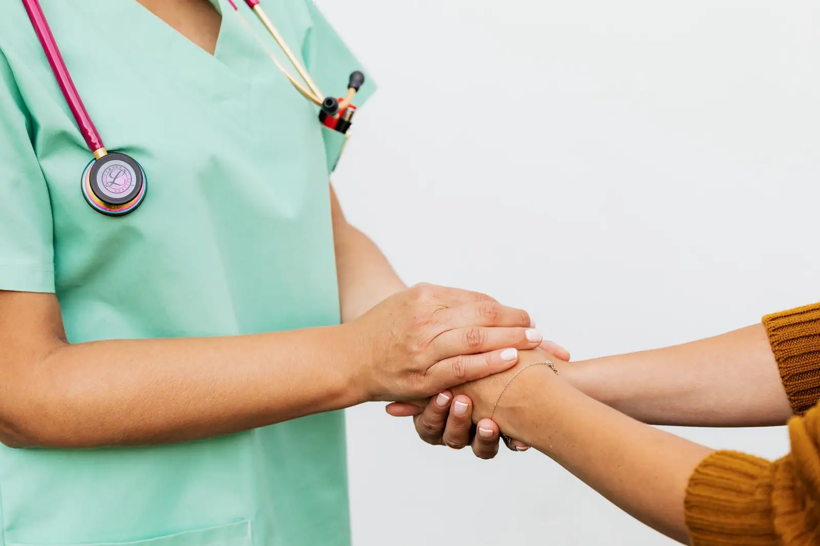A doctor holding a patient's hands
