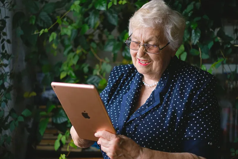 A grandmother video-calling family from the garden