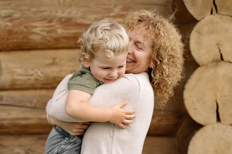 A grandmother holding her grandson close