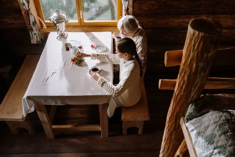 A grandmother and granddaughter having tea