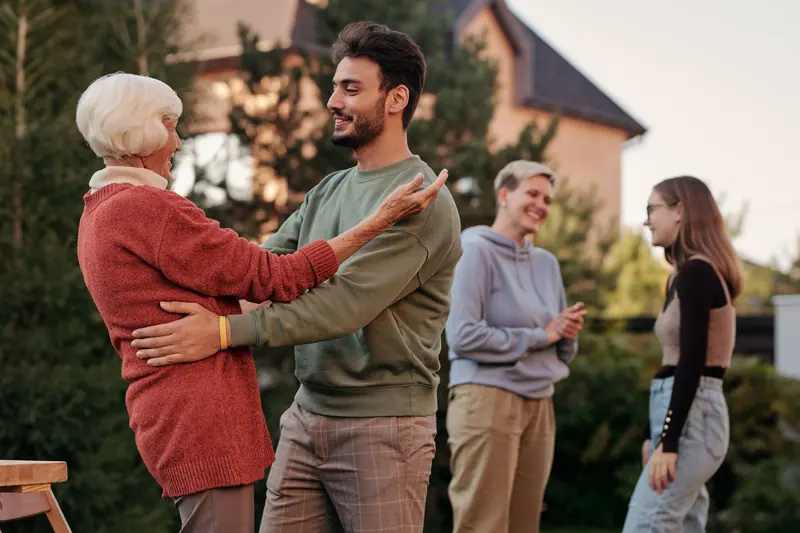 A family hugging at a backyard gathering
