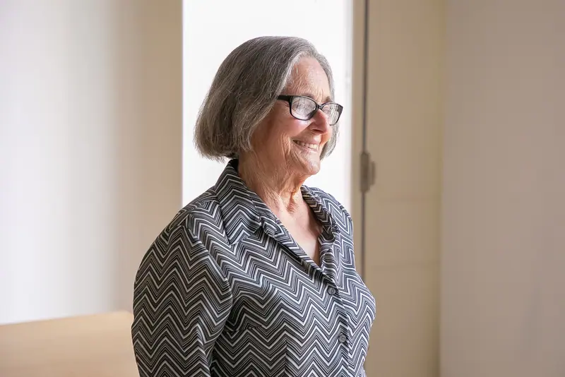 A woman smiling out the window