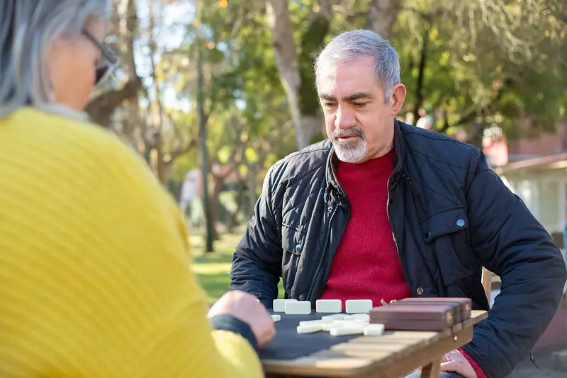 A father playing dominoes in the park