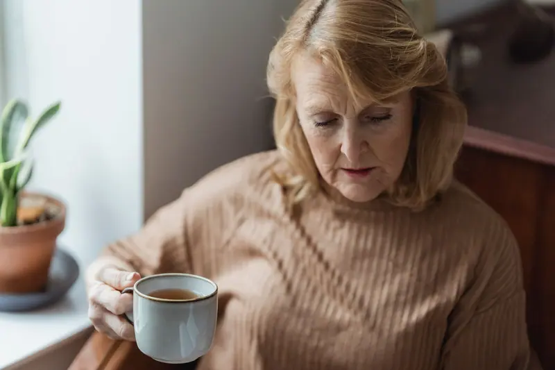 A woman with her tea by the window