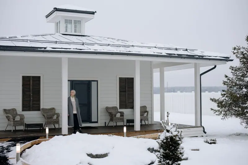 A woman on a snowy porch