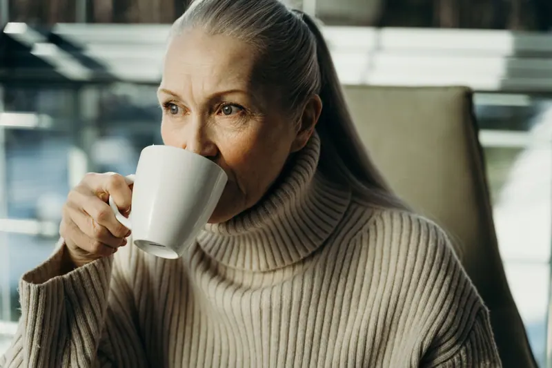 A woman sipping her coffee in her favorite chair