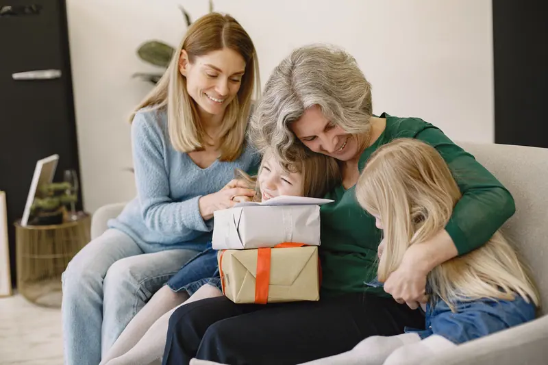 A family gathering around Grandma with birthday presents