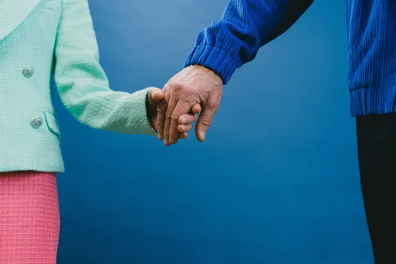 A married couple holding hands