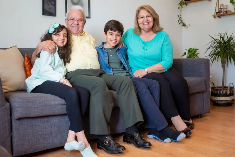 Grandparents on the sofa with their grandkids