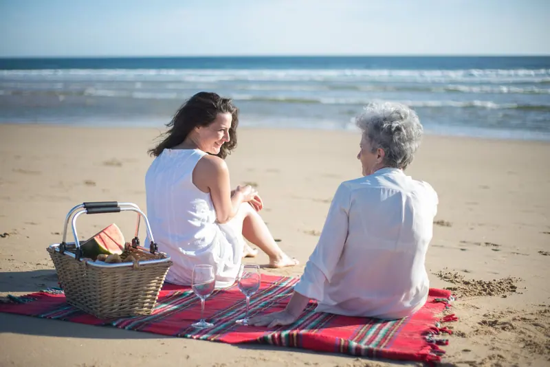A mother and daughter on a picnic blanket