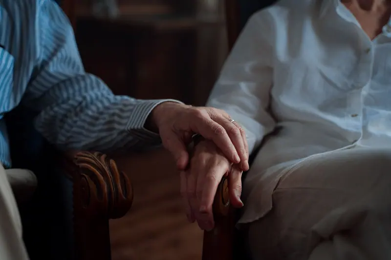An old married couple's hands intertwined