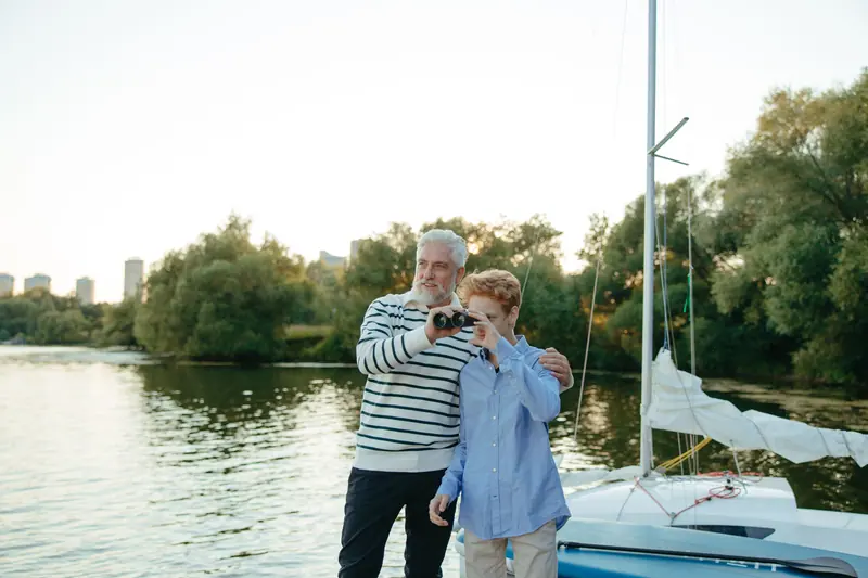 A grandfather and grandson getting the fishing poles ready