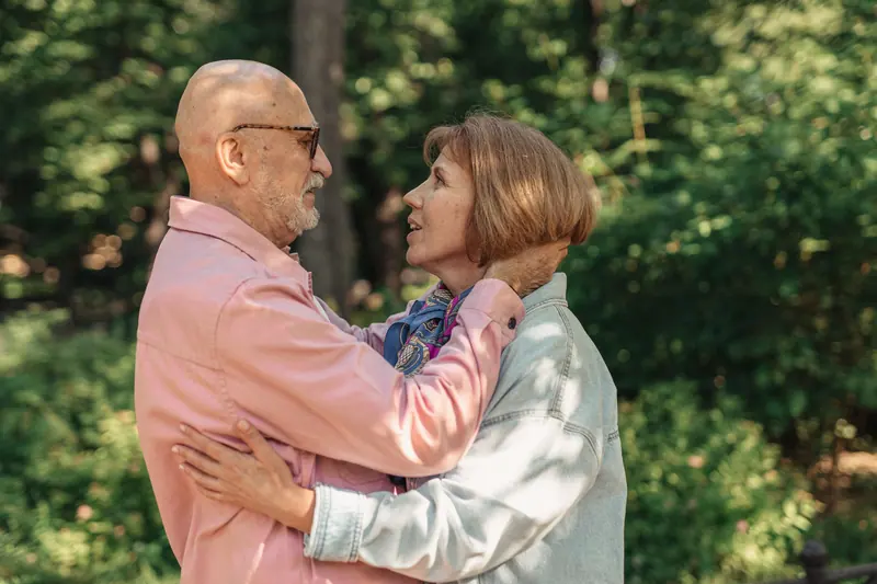 A husband and wife embracing in the garden
