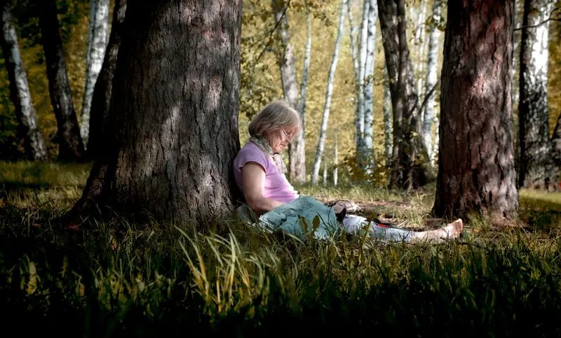 A woman sitting beneath a tree