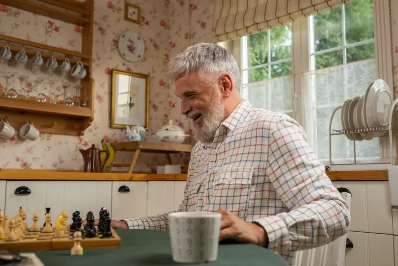A resident at the chessboard in the kitchen