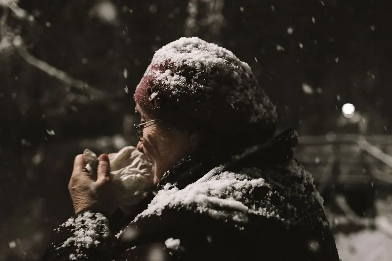 A resident bundled up in the first snow