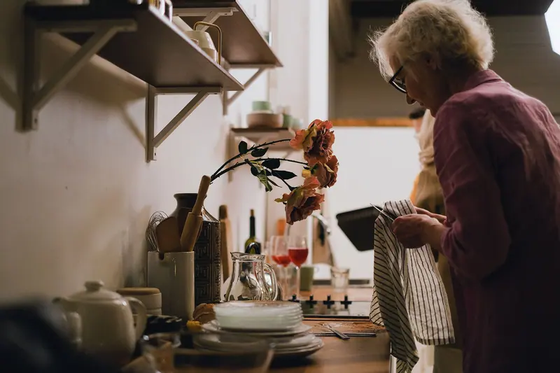 A resident in the sunny kitchen