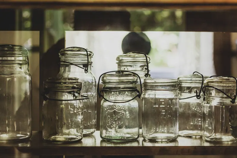Clean canning jars lined up by the window
