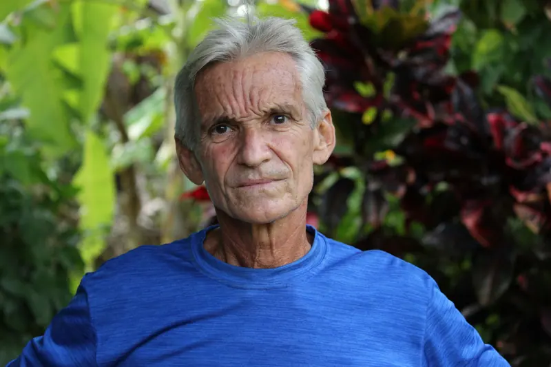 A resident in a blue shirt resting in the garden