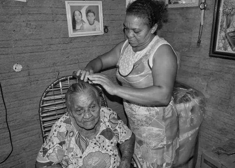 A caregiver brushing a resident's hair