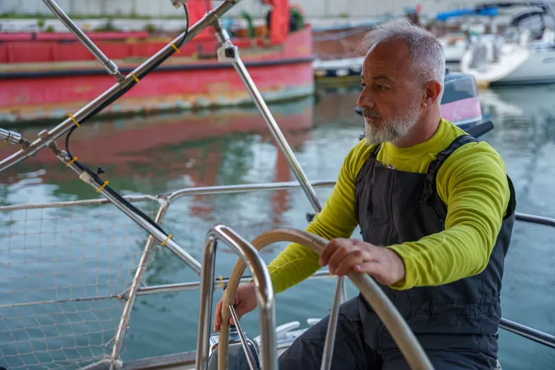 A resident at the wheel of a friend's boat