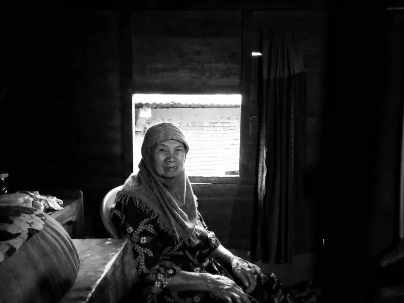 A resident sitting in the quiet of her room by the window