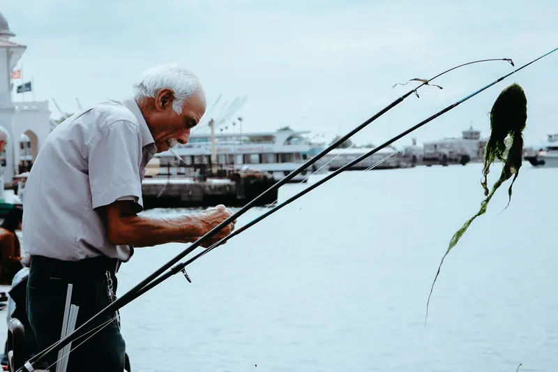 A resident baiting his line on the pier