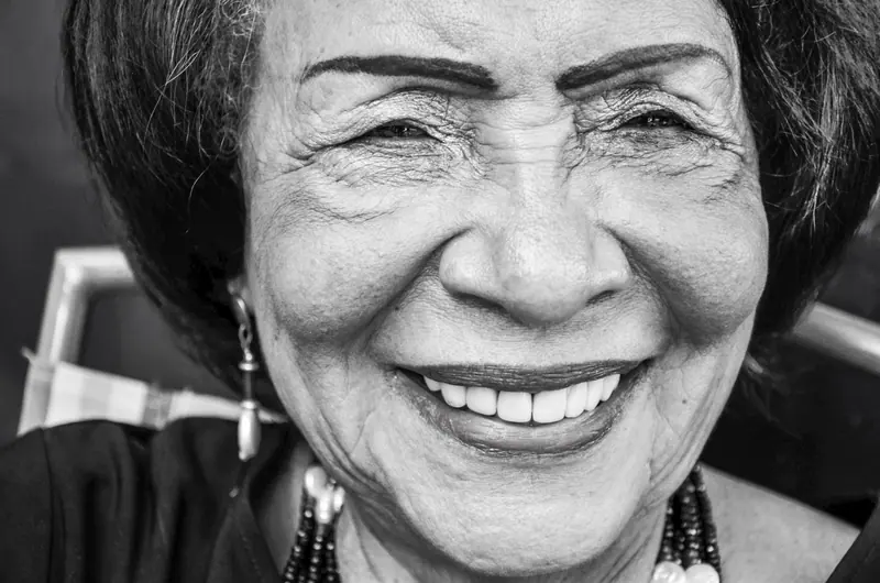 Close portrait of a resident with a wide smile and earrings