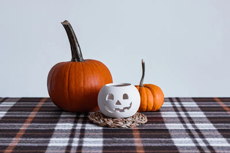 A pumpkin on a plaid tablecloth