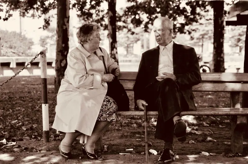 A couple on a bench in the fall