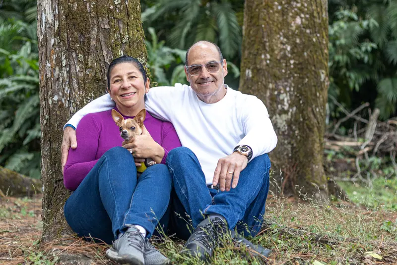 A married couple sitting together under the pecan trees