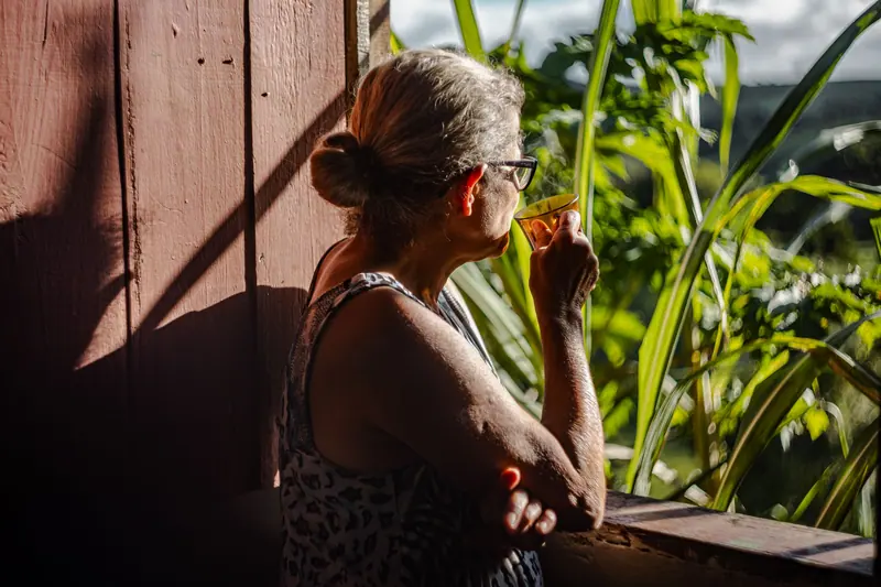 A resident by a sunny window with her morning tea