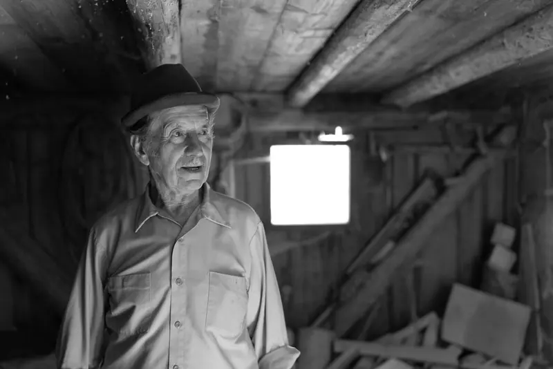 A resident in his workshop, in black and white