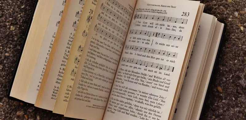 The worn pages of a hymnal