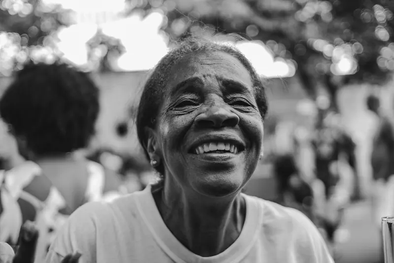 Black-and-white portrait of a resident laughing at a joke