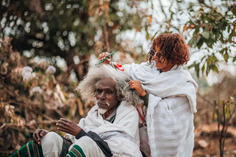 A resident and her daughter laughing under the autumn trees
