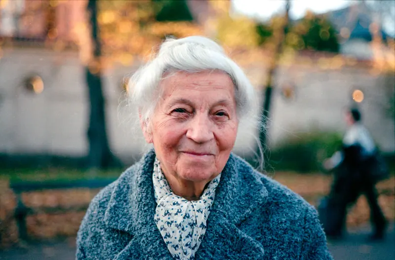 A resident in a blue coat in the October light
