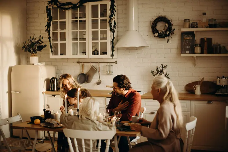 Families sharing supper at the long kitchen table