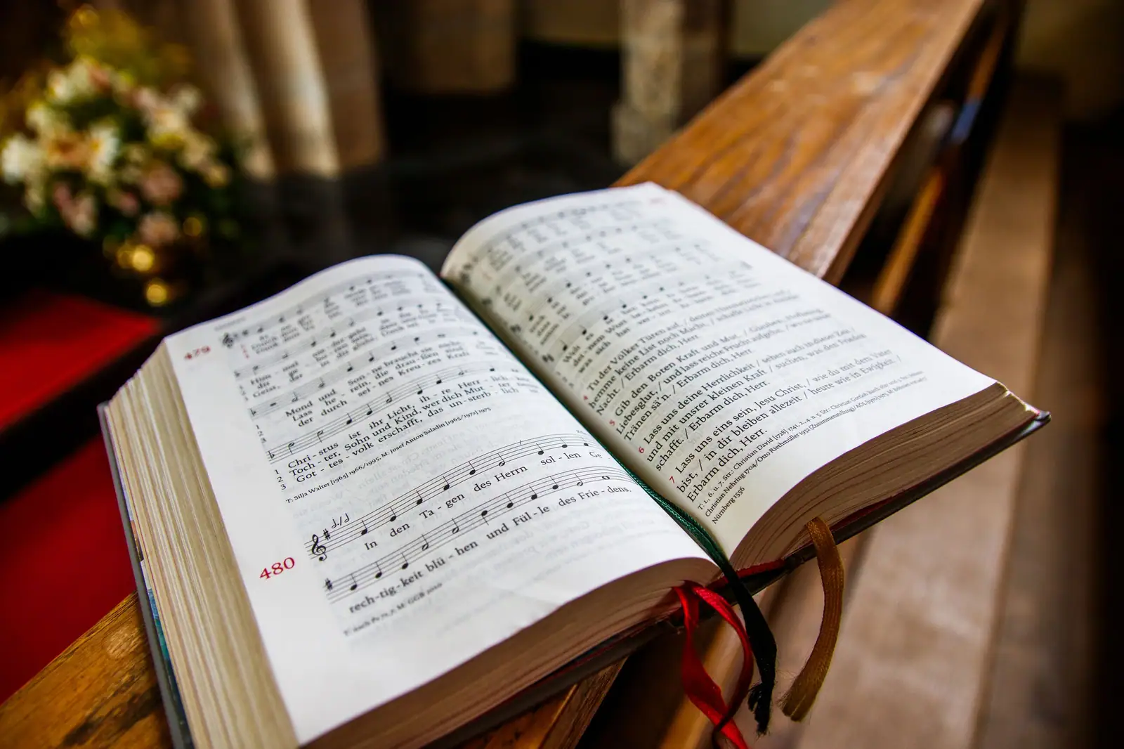 An open hymnal on the chapel pew