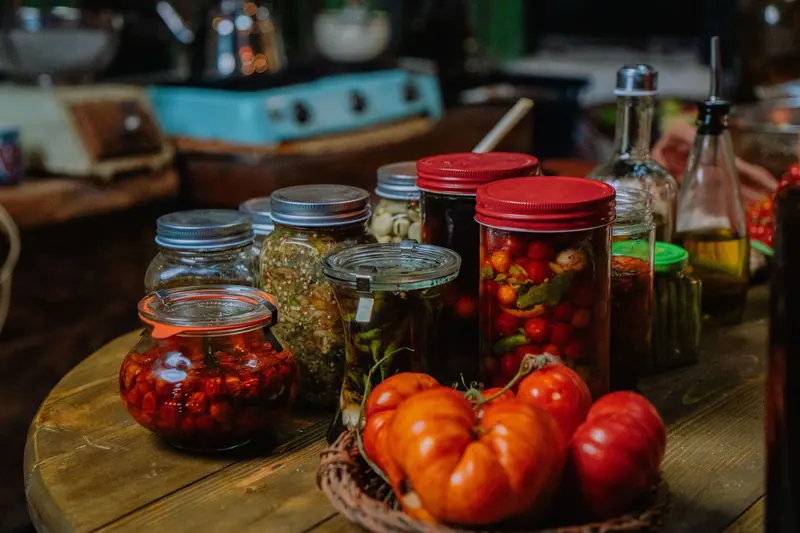 Jars of pickled vegetables and garden tomatoes