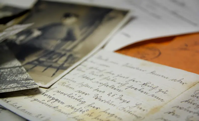Old photographs and handwritten letters on the writing table