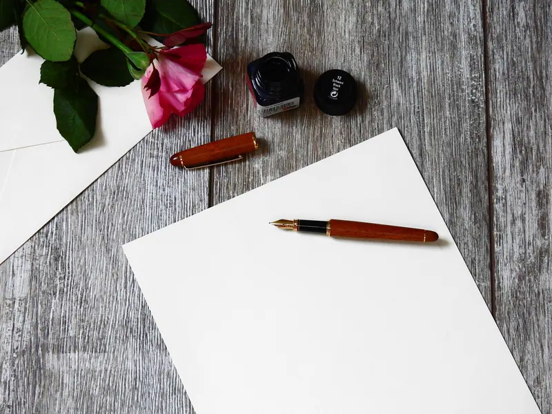 A fountain pen and fresh paper on the writing desk