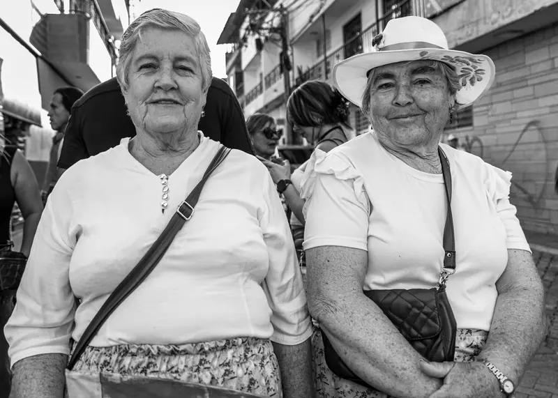 Two residents in sun hats, black and white