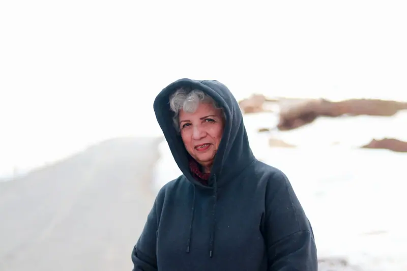 A resident in a hooded coat on a winter walk